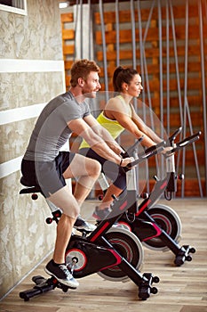 Couple trains on bike in gym photo