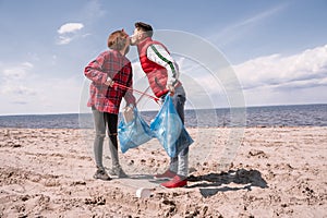 couple with trash bags and grabbers