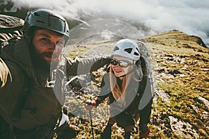 Couple travel selfie man and woman hiking in mountains love and adventure