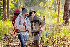 Couple travelers with backpacks relaxing on mountain