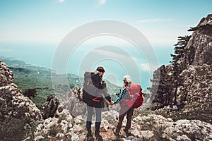 Couple travelers Man and Woman holding hands enjoying mountains aerial view