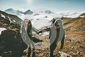 Couple travelers Man and Woman holding hands hiking