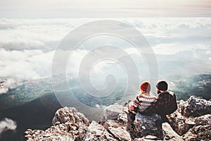 Couple travelers Man and Woman sitting on cliff