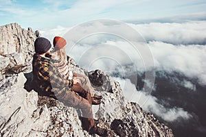 Couple travelers Man and Woman sitting on rocks