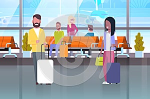 Couple Of Travelers With Suitcases At Waiting Hall Or Departure Lounge People In Airport Terminal