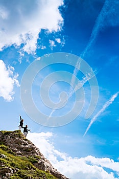 Couple of travelers on top of a mountain. Mangart, Julian Alps,