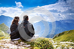 Couple of travelers on top of a mountain. Mangart, Julian Alps,