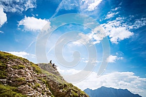 Couple of travelers on top of a mountain. Mangart, Julian Alps,