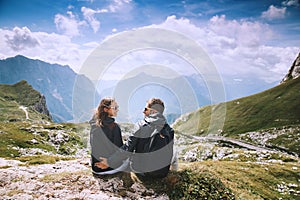 Couple of travelers on top of a mountain. Mangart, Julian Alps, Slovenia.