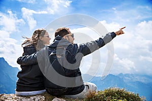 Couple of travelers on top of a mountain. Mangart, Julian Alps, Slovenia.