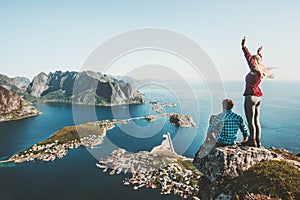 Couple travelers traveling together on top cliff photo