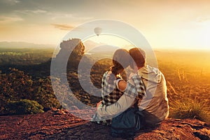 Couple travelers watch beautiful sunset near famous rocky plateau Lion peak, Sigiriya. Sri Lanka