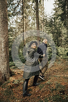 Couple travelers woman and man follow holding hands at mountains with landscape on background. happy emotions