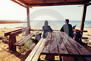 Couple of travelers on wooden veranda