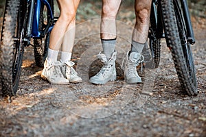 Couple traveling with bicycles in the forest