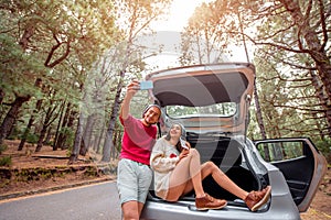 Couple traveling by car in the forest