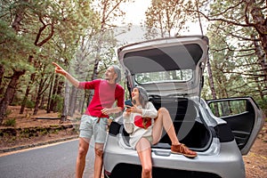 Couple traveling by car in the forest