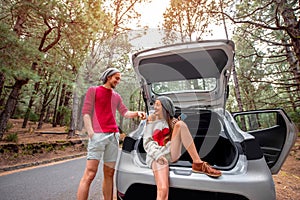 Couple traveling by car in the forest