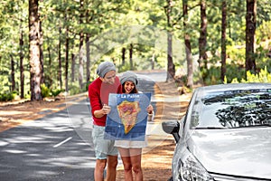 Couple traveling by car in the forest