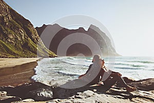 Couple traveling together relaxing on Kvalvika beach in Norway