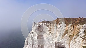 Couple traveling together on white cliff edge on blue sky background, lifestyle concept. Action. Young couple of
