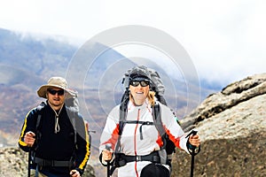 Couple trekkers hiking in mountains