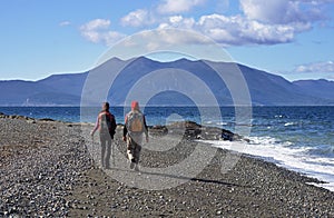 Couple Trekking On Beach