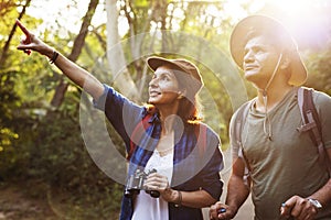 Couple trekking together into forest