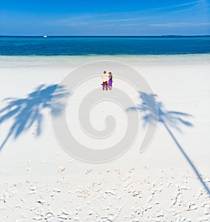 Couple on tropical beach at Pasir Panjang, Kei Islands, tropical archipelago Indonesia, Moluccas, coral reef white sand beach