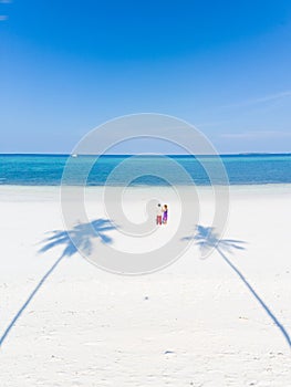 Couple on tropical beach at Pasir Panjang, Kei Islands, tropical archipelago Indonesia, Moluccas, coral reef white sand beach