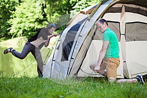 Couple trying to pitch a tent