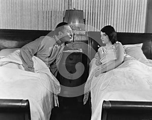 Couple in twin beds photo