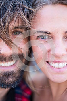 Couple of two adults and beautiful and attractive people looking at the camera - portrait and close up of woman and man smiling