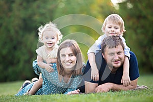 Couple with two kids in park