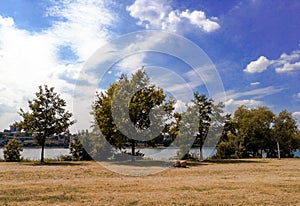 A couple of two males shirtless spending time together on picnic by the Rhine river in the city of Bonn