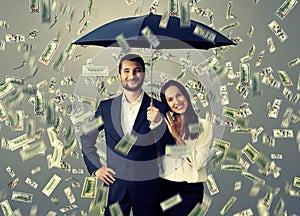 Couple under money rain