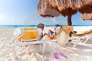 Couple under parasol at Caribbean Sea