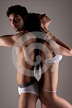 Couple In Underwear Standing Back To Back