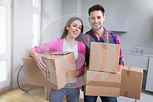 Couple with unpacked boxes in new home