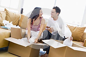 Couple unpacking boxes in new home