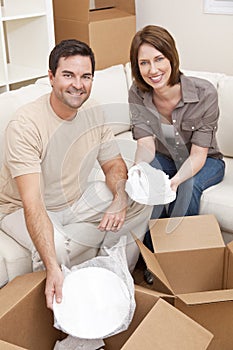 Couple Unpacking or Packing Boxes Moving House
