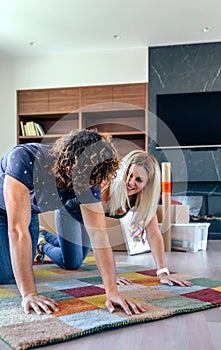 Couple unrolling the carpet