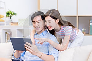 Couple use tablet at home
