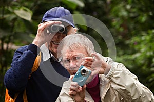 Couple Using Camera and Binoculars