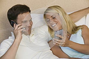 Couple Using Cell Phone and PDA