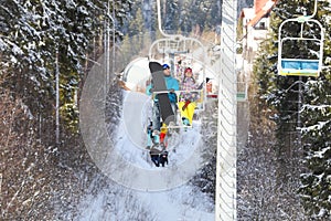 Couple using chairlift at mountain ski resort. Winter vacation