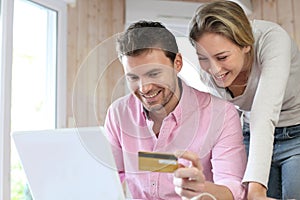 Couple using credit card and shopping online