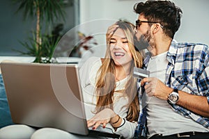 Couple using credit card to shop on internet