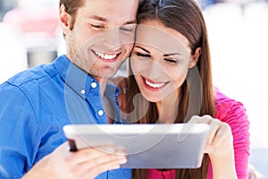 Couple using digital tablet