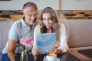 Couple using digital tablet